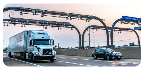 Car and truck driving through Illinois Tollway toll plaza